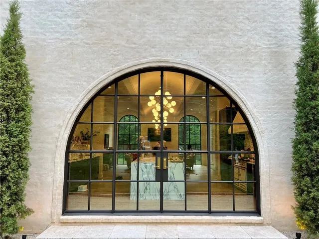 a view of a brick house and a large window