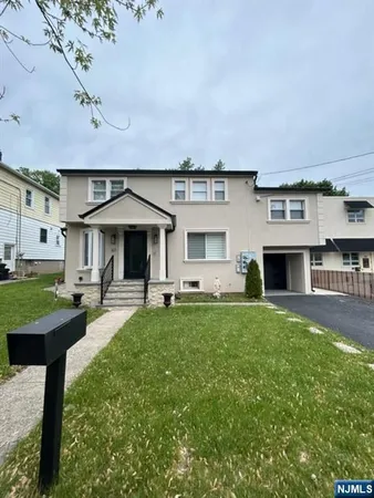 a front view of a house with a yard table and chairs
