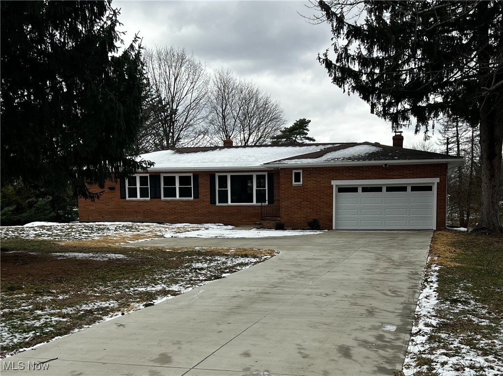 10356 Broadview Road Broadview Heights, OH 44147 - Photo 22 of 24 Ranch-style home with a chimney, a garage, brick siding, and driveway