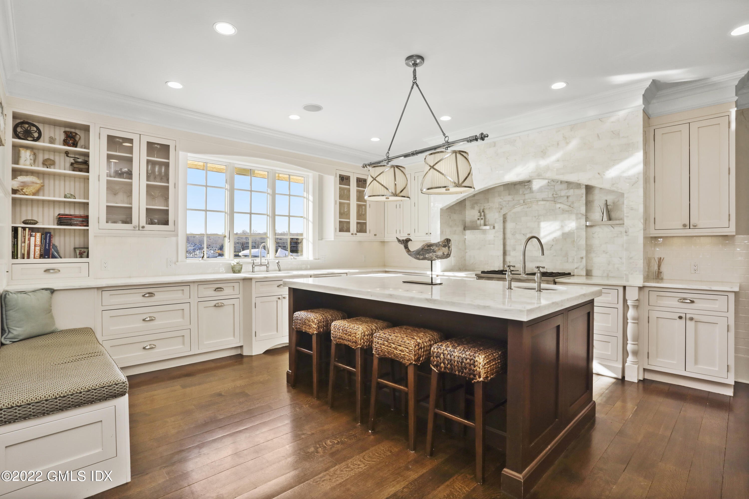 30 Bayside Terrace Riverside, CT 06878 - Photo 21 of 50 a kitchen with kitchen island granite countertop a sink a counter space appliances and cabinets