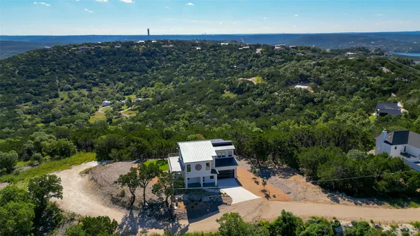 an aerial view of a house with a yard
