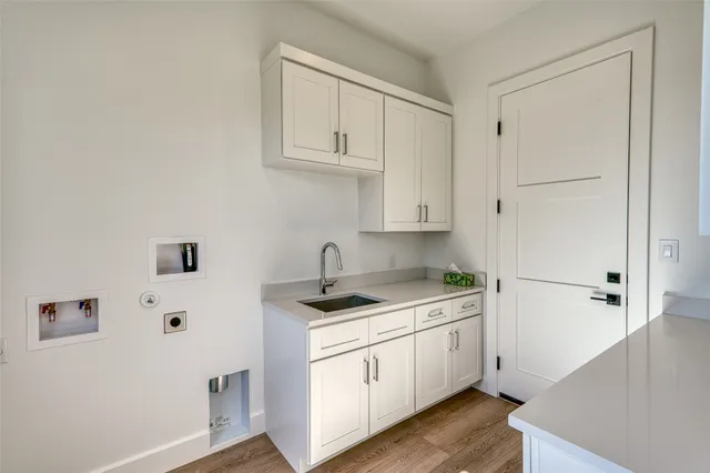 a kitchen with white cabinets and white appliances