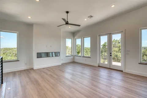 a view of a room with wooden floor