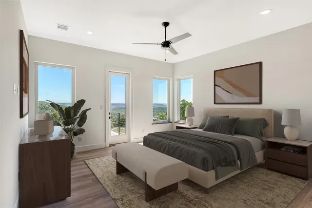 a bedroom with a large bed and a potted plant