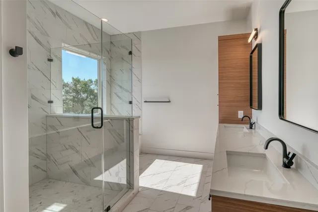 a bathroom with a shower and a sink