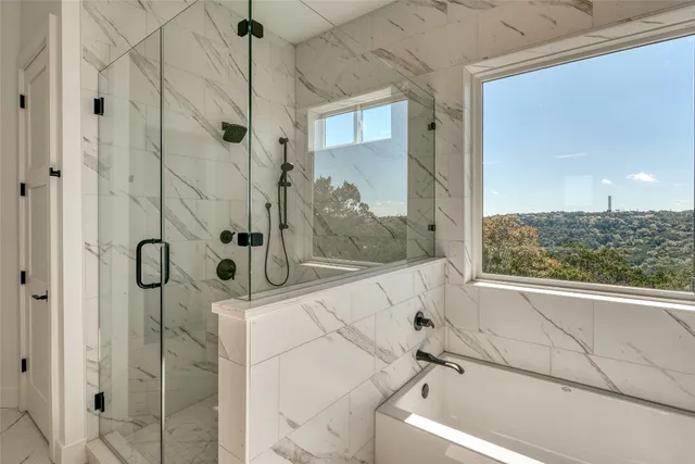 a bathroom with a bathtub and shower