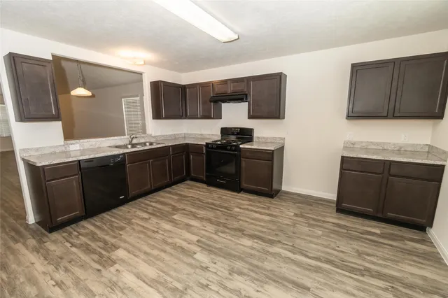 a kitchen with stainless steel appliances granite countertop a sink and cabinets