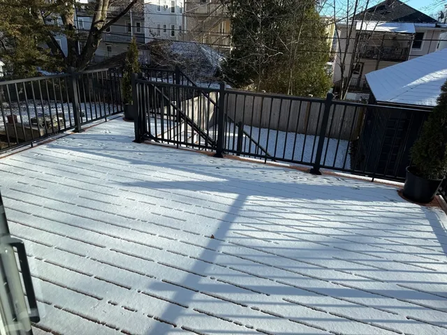 a view of terrace with wooden floor and outdoor seating