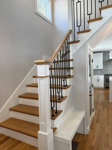 a view of entryway and hall with wooden floor