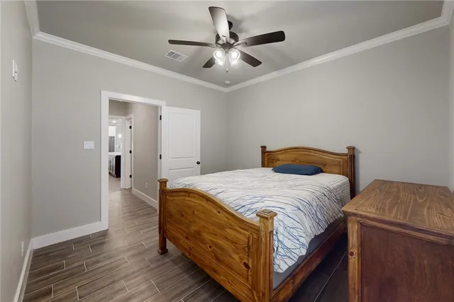 a bedroom with a bed and wooden floor
