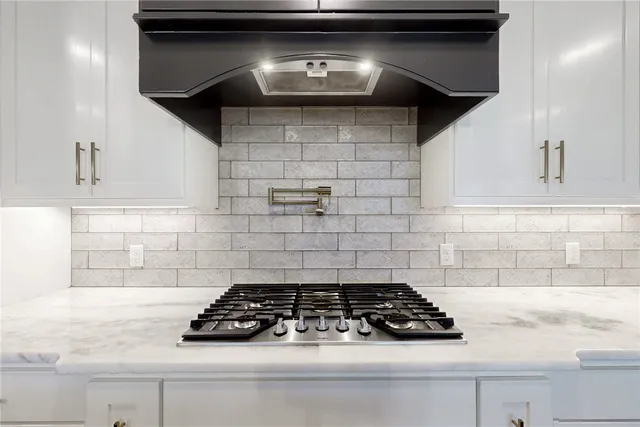 a white stove top oven sitting inside of a kitchen
