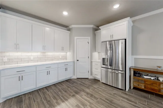a kitchen with granite countertop white cabinets and stainless steel appliances