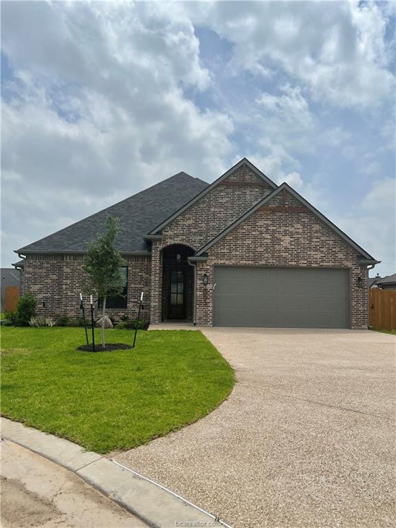3005 Alpha Court Bryan, TX 77808 - Photo 2 of 37 French country style house with brick siding, a front yard, a garage, and driveway