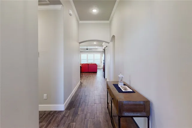 a view of a hallway with wooden floor