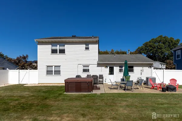 a view of a house with backyard and sitting area
