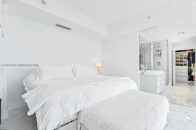 a bedroom with a flat screen tv and a bed