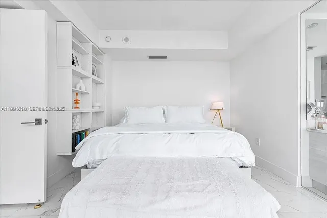 a large white room with a large window and a table