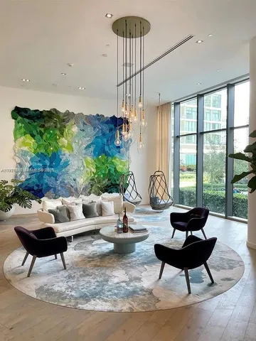 a living room with furniture and a chandelier