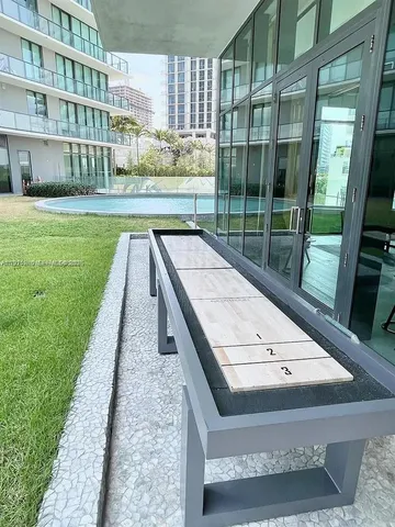a living room with furniture large window and a table