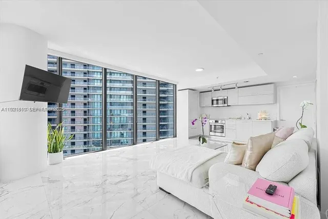a kitchen with white cabinets stainless steel appliances and a sink