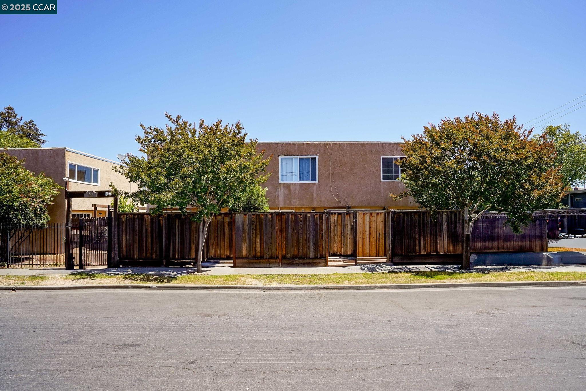 a view of swimming pool with wooden fence