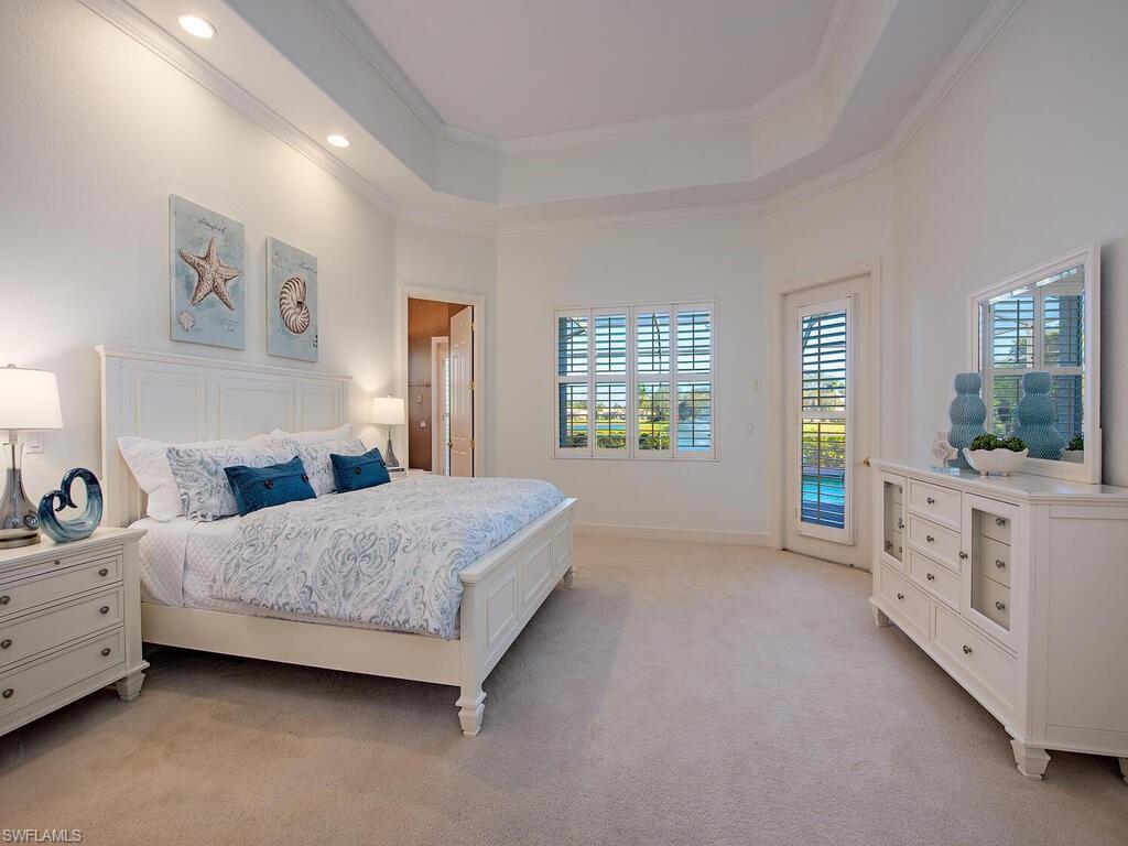 427 Terracina Way Naples, FL 34119 - Photo 13 of 17 Primary bedroom - Lake and fountain views. Access to pool area
