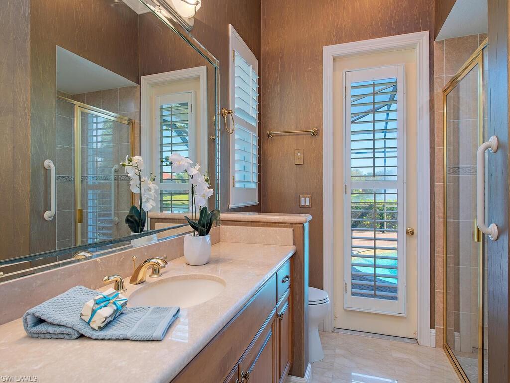 427 Terracina Way Naples, FL 34119 - Photo 14 of 17 One of the two primary baths - shower and access to pool