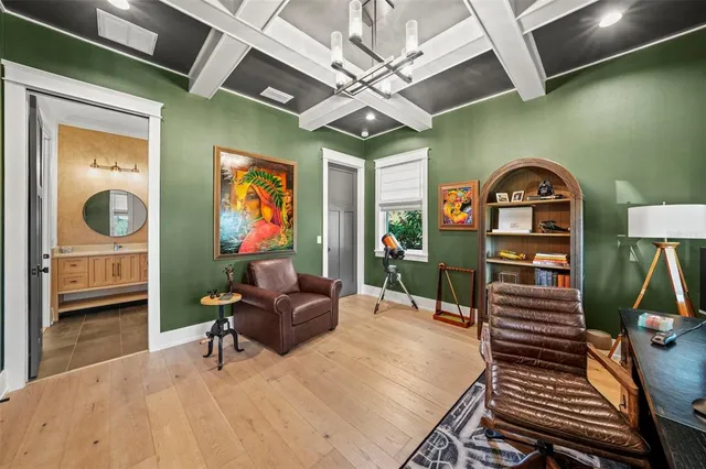 a living room with furniture a piano and a flat screen tv