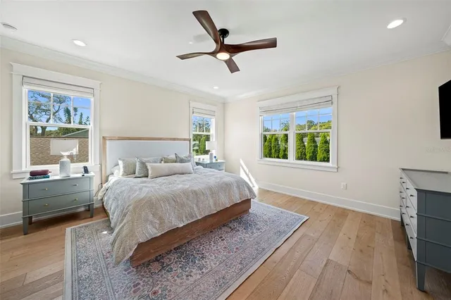 a bedroom with a bed and a large window