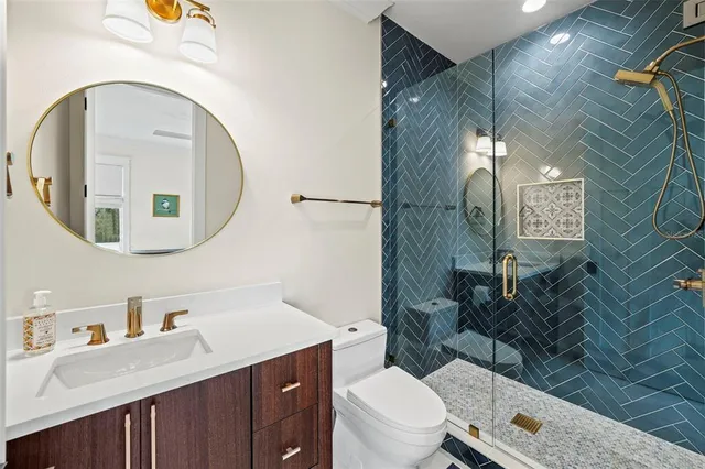 a bathroom with a toilet a sink and mirror