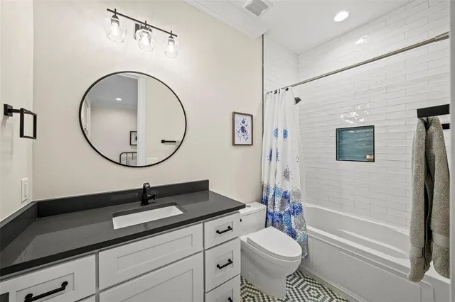 a bathroom with a toilet a sink and a mirror