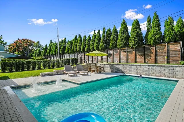 a view of the patio with couches and table under an umbrella
