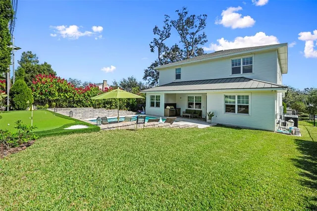 an aerial view of residential houses with outdoor space and swimming pool
