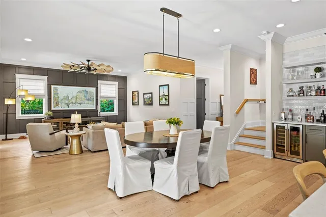 a dining room with furniture a chandelier and wooden floor