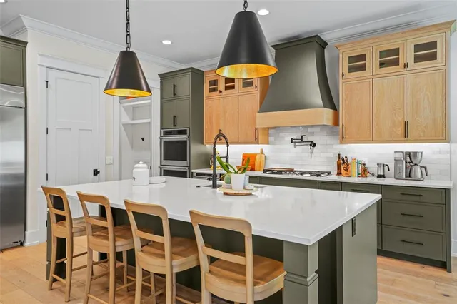 a kitchen with a dining table chairs and wooden floor