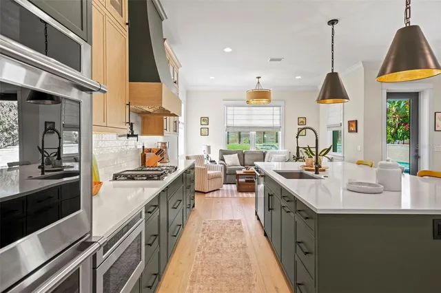 a kitchen with sink stove and cabinets