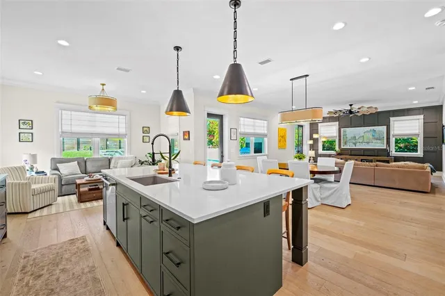 a kitchen island with stainless steel appliances sink stove and wooden floor