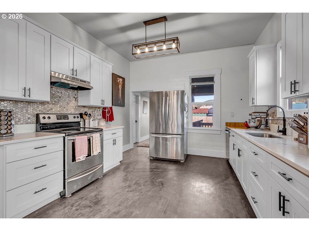 519 West Main Street Sheridan, OR 97378 - Photo 14 of 41 a kitchen with stainless steel appliances white cabinets and a refrigerator