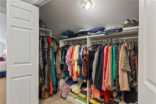 a view of walk in closet with clothes