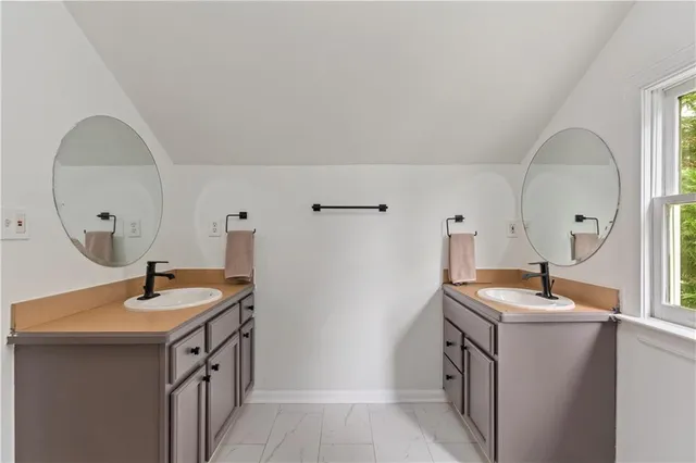 a room with a sink and a mirror