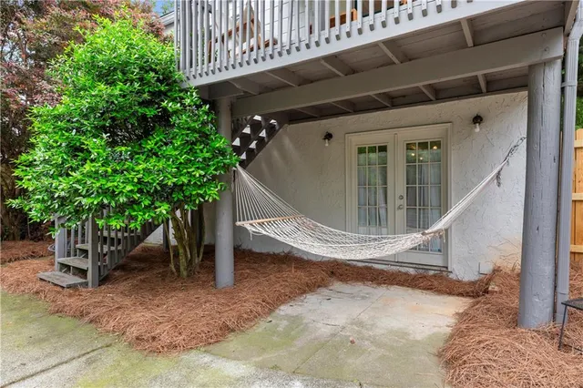 a front view of a house with a yard and trees