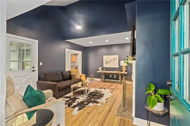 a living room with furniture and a wooden floor