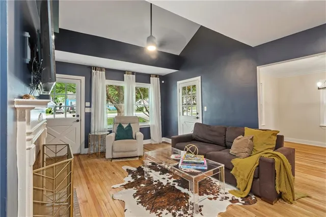 a living room with furniture fireplace and a large window