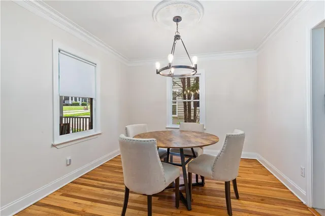 a view of a dining room with a table and chairs