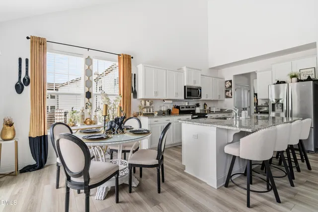 a dining room with furniture and window