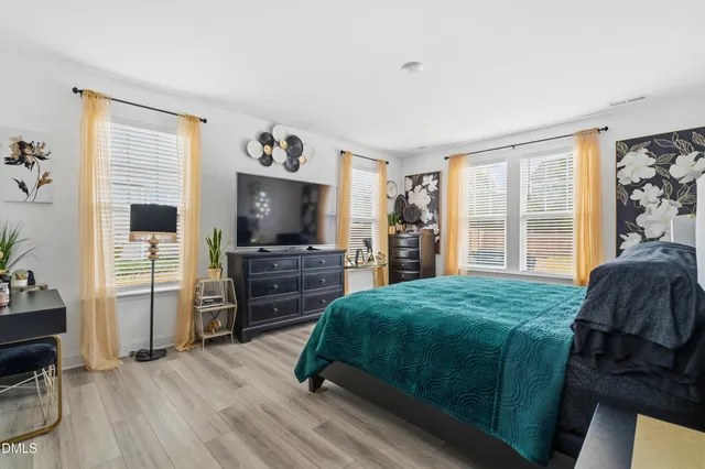 a bedroom with a bed and a television