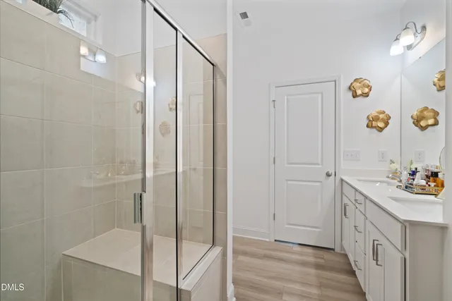 a bathroom with a double vanity sink and a mirror