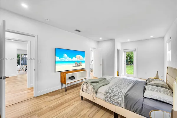 a view of entryway and hall with wooden floor