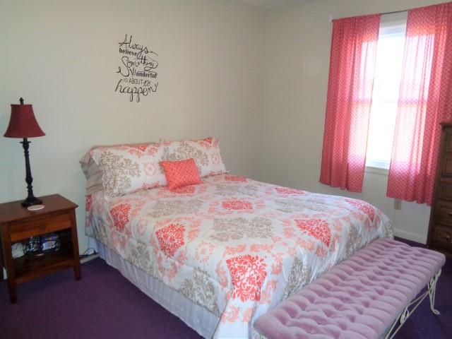 2069 Fall River Road Leoma, TN 38468 - Photo 15 of 26 a bedroom with a bed and a chandelier