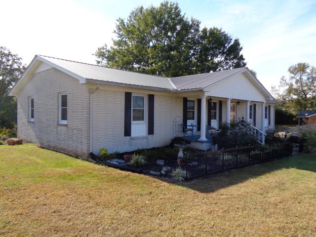 2069 Fall River Road Leoma, TN 38468 - Photo 21 of 26 a front view of a house with a yard and garage